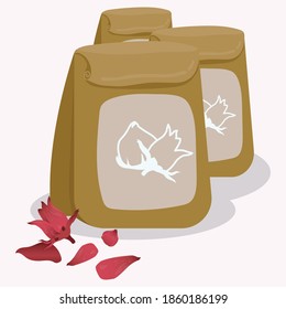 Dried okra flowers are packed in brown paper bags, on the front of the sachet, there is an icon labeled with roselle. Beside the brown bag, there are fresh okra flowers placed with
