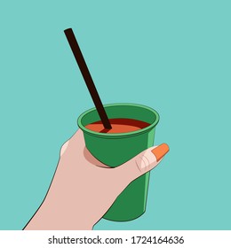Drink in the hand. Summer refreshing cocktail. Glass with soda in hand. A straw in a drink. Hot sunny day. Relax on the beach.