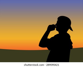 Drinking guy silhouette with sunset sky 