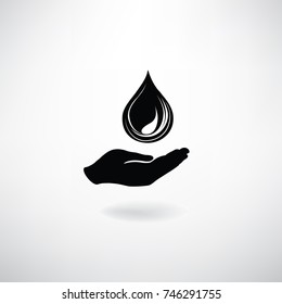 Drop icon in hand silhouette. Save water symbol