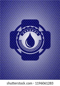 drop icon inside badge with denim background