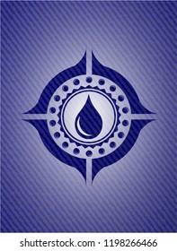 drop icon inside badge with denim background