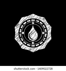 drop icon inside chalkboard emblem written on a blackboard