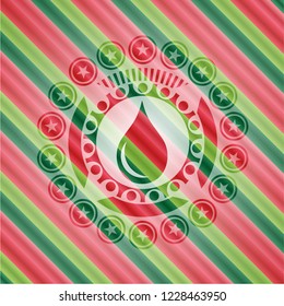 drop icon inside christmas colors badge.