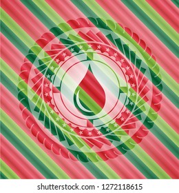 drop icon inside christmas colors style emblem.
