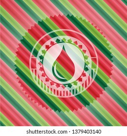 drop icon inside christmas colors badge.
