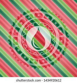 drop icon inside christmas colors style badge.