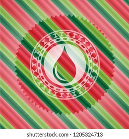 drop icon inside christmas emblem.
