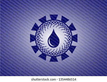 drop icon inside emblem with jean background