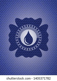 drop icon inside emblem with jean background