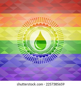 drop icon inside emblem on mosaic background with the colors of the LGBT flag. 