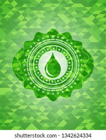 drop icon inside green emblem with mosaic ecological style background