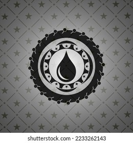 drop icon inside realistic dark emblem. 