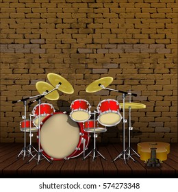 Drum kit and guitar on the background of an old brick wall with wooden floors.