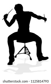 A drummer musician drumming drums in detailed silhouette