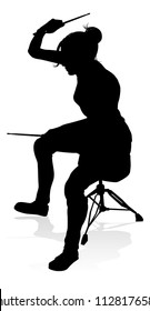 A drummer musician drumming drums in detailed silhouette