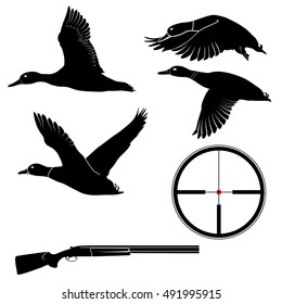 Duck hunting set of flying ducks, shotgun and crosshairs of the optical sight. Set of black silhouettes of wild ducks, a hunting rifle and a sight for the design and advertising of duck hunting