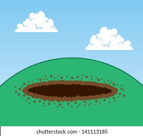 Dug hole on top of a hill 