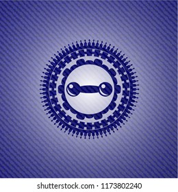 dumbbell icon inside badge with denim texture