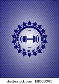 dumbbell icon inside badge with denim background