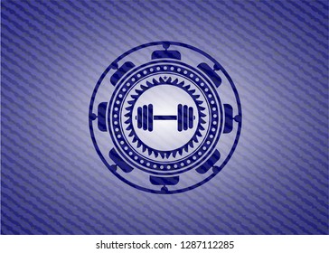 dumbbell icon inside badge with denim texture