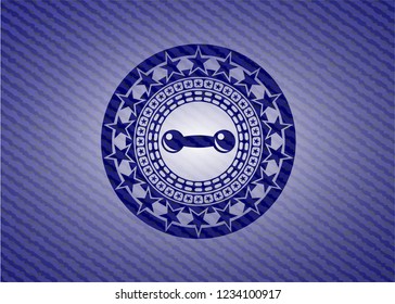 dumbbell icon inside badge with jean texture