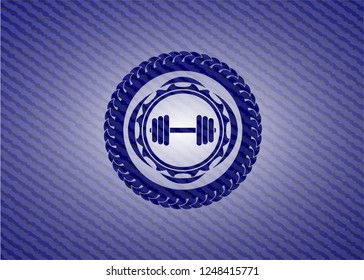 dumbbell icon inside badge with jean texture