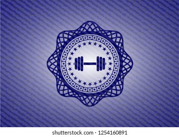dumbbell icon inside badge with jean texture