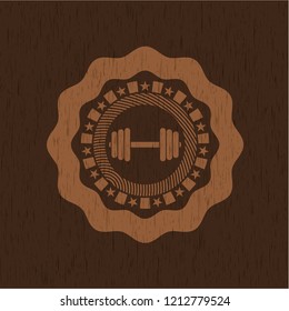 dumbbell icon inside badge with wood background