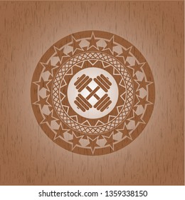 dumbbell icon inside badge with wood background