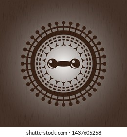 dumbbell icon inside badge with wooden background