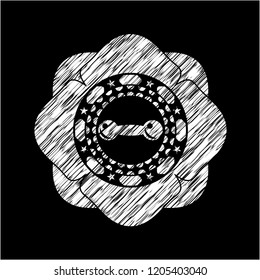 dumbbell icon inside chalk emblem written on a blackboard