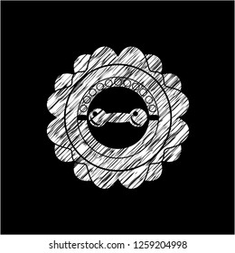 dumbbell icon inside chalk emblem written on a blackboard