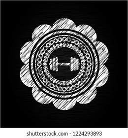 dumbbell icon inside chalkboard emblem on black board