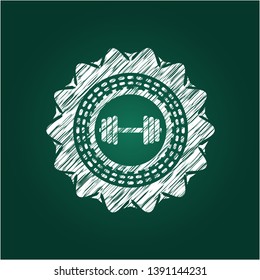 dumbbell icon inside chalkboard emblem on black board