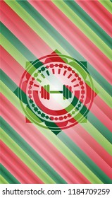 dumbbell icon inside christmas colors badge.