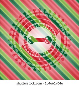 dumbbell icon inside christmas colors badge.