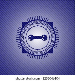 dumbbell icon inside denim background