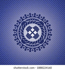 dumbbell icon inside denim background. 
