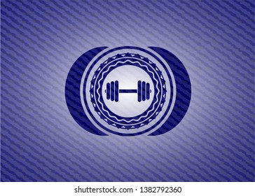 dumbbell icon inside emblem with denim high quality background
