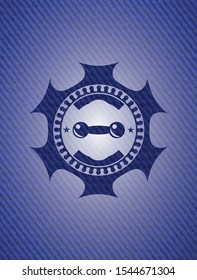 dumbbell icon inside emblem with denim texture