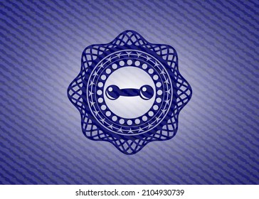 dumbbell icon inside emblem with denim texture. 