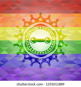 dumbbell icon inside emblem on mosaic background with the colors of the LGBT flag