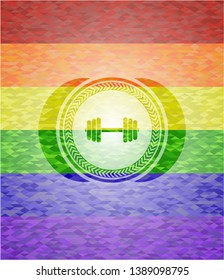 dumbbell icon inside emblem on mosaic background with the colors of the LGBT flag