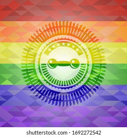 dumbbell icon inside emblem on mosaic background with the colors of the LGBT flag