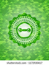dumbbell icon inside green emblem with mosaic background