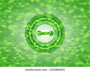 dumbbell icon inside green emblem with triangle mosaic background