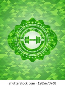 dumbbell icon inside green emblem with mosaic background