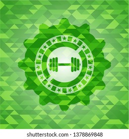 dumbbell icon inside green emblem with triangle mosaic background