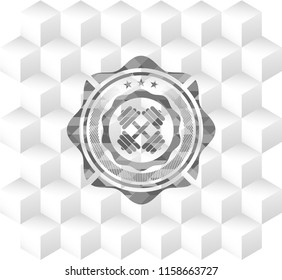 dumbbell icon inside grey badge with geometric cube white background